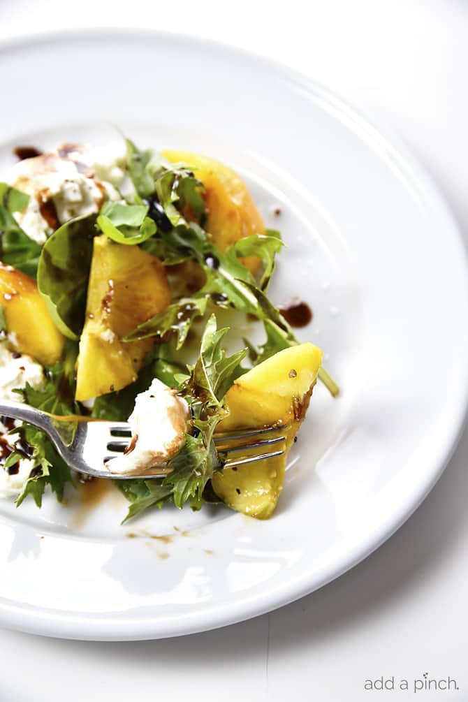 Peach, Basil and Burrata Salad Recipe - A delicious take on a traditional caprese salad, this peach, basil and burrata salad comes together in minutes and is just as delicious as it is beautiful. // addapinch.com
