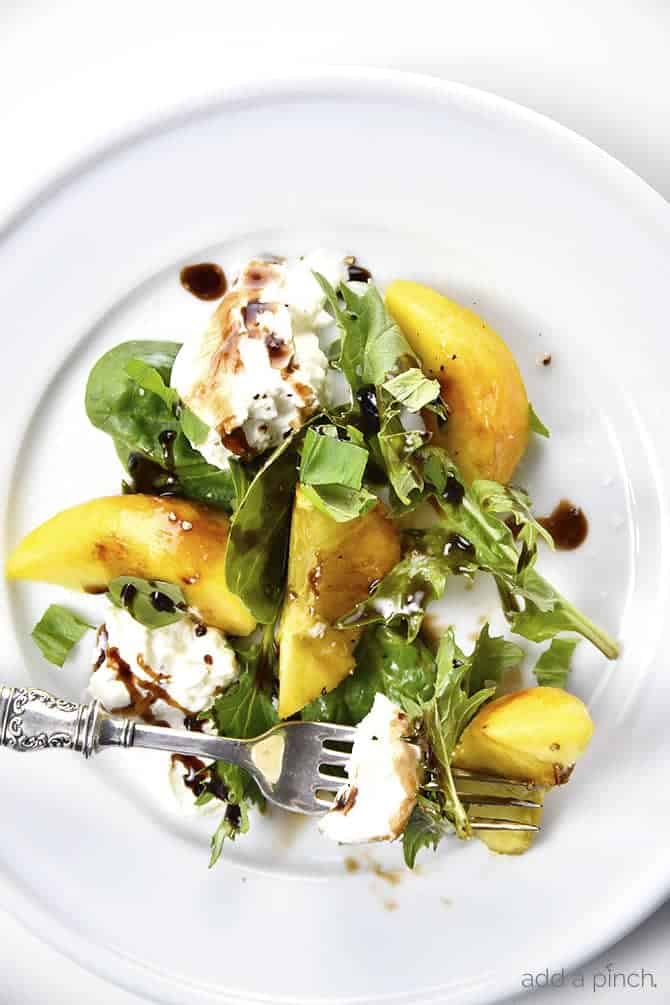 Peach, Basil and Burrata Salad Recipe - A delicious take on a traditional caprese salad, this peach, basil and burrata salad comes together in minutes and is just as delicious as it is beautiful. // addapinch.com