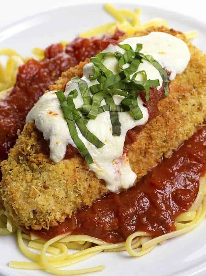 Baked Chicken Parmesan Recipe - This baked chicken parmesan recipe includes everything you love about chicken parmesan without all the guilt or mess! // addapinch.com