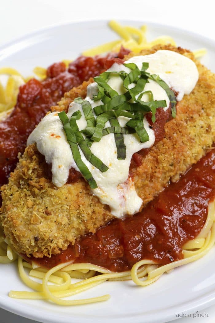 Baked Chicken Parmesan Recipe - This baked chicken parmesan recipe includes everything you love about chicken parmesan without all the guilt or mess! // addapinch.com