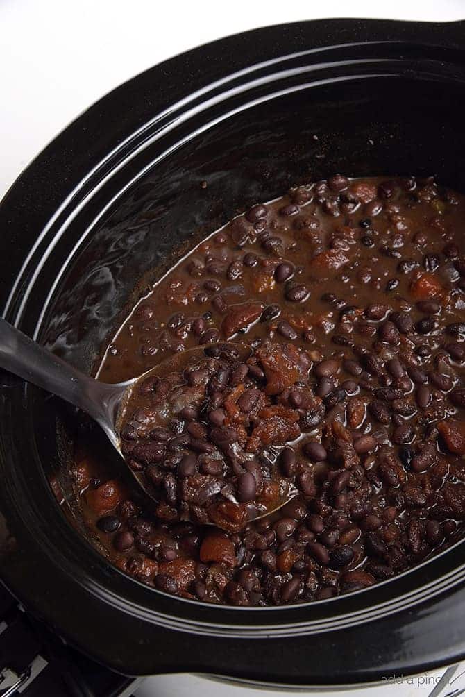 Black Bean Soup Recipe - This delicious black bean soup is packed with flavor and made even easier with the slow cooker! // addapinch.com