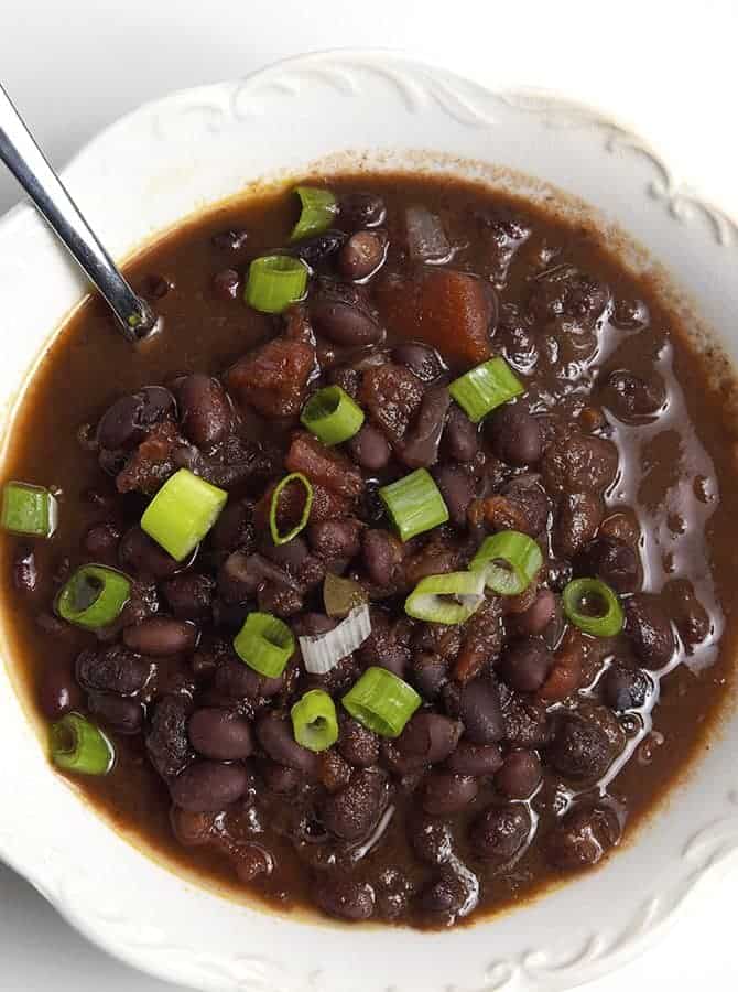 Black Bean Soup Recipe - This delicious black bean soup is packed with flavor and made even easier with the slow cooker! // addapinch.com