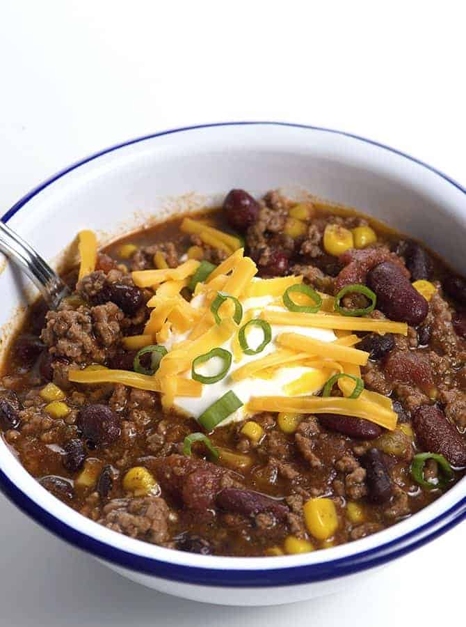 Taco Soup Recipe - So quick and easy, this taco soup recipe is flavorful and delicious! Made with ground beef, beans, corn, it is on the table in less than 30 minutes! // addapinch.com