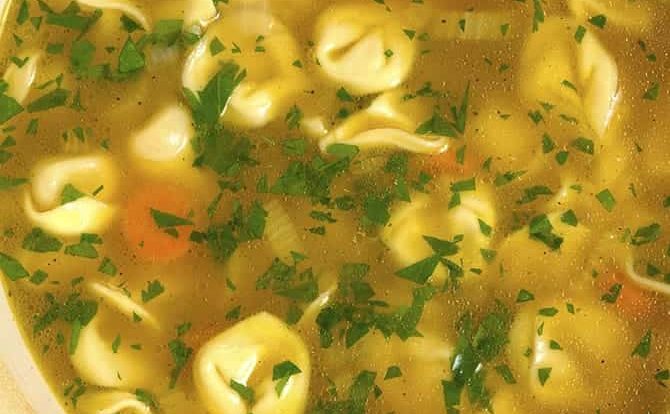 Tortellini Soup is perfect for busy nights! Made with vegetables, cheesy tortellini and topped with fresh parmesan! Ready and on the table in 30 minutes! // addapinch.com