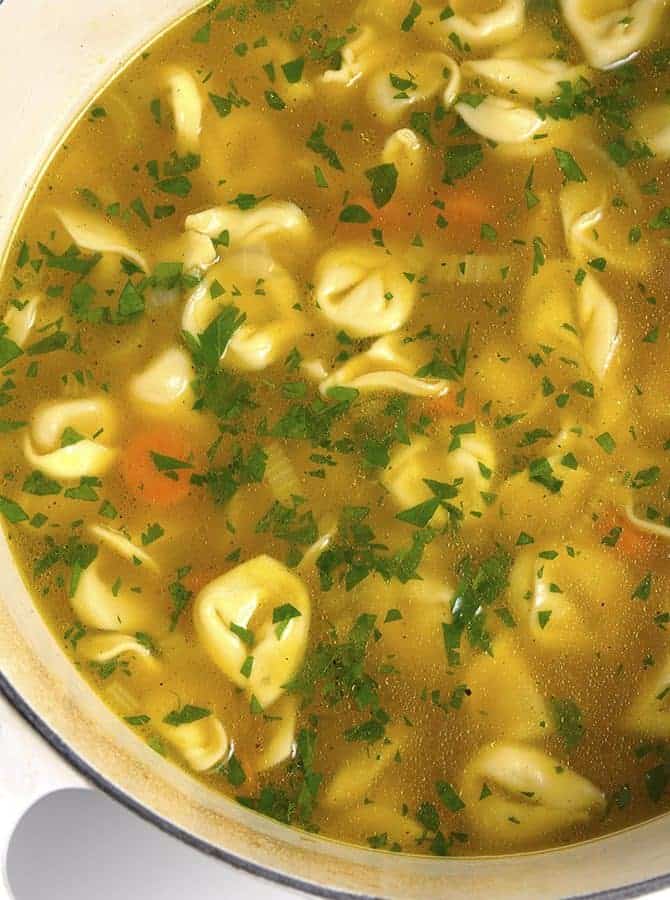 Tortellini Soup is perfect for busy nights! Made with vegetables, cheesy tortellini and topped with fresh parmesan! Ready and on the table in 30 minutes! // addapinch.com
