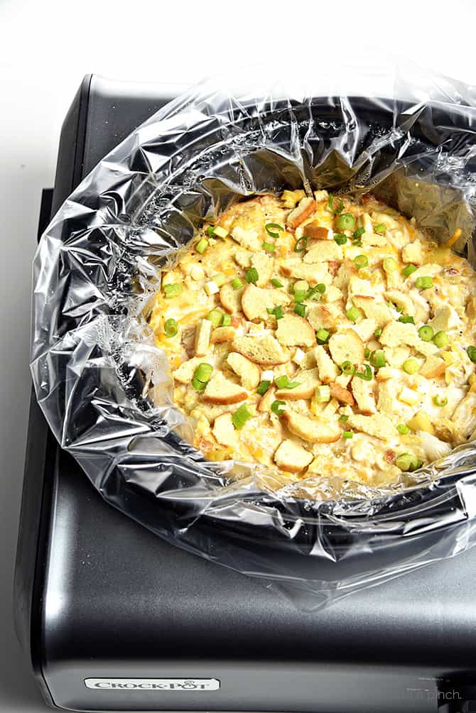 Slow Cooker Hot Crab Artichoke Dip Recipe - A delicious hot crab artichoke dip recipe made even easier with the slow cooker! Serve with butter crackers or toasted bagels! Always a party favorite! // addapinch.com