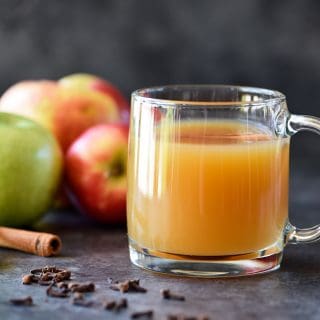 Homemade Apple Cider Recipe - Easy and delicious homemade apple cider recipe made with apples, oranges, cinnamon, and cloves. Stovetop and slow cooker instructions included! // addapinch.com