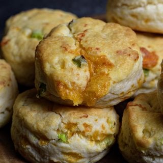 Cheddar Scallion Biscuits Recipe - Tender and delicious, these fluffy, cheesy cheddar scallion biscuits make the perfect addition to any meal and couldn't be easier! // addapinch.com