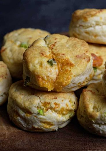 Cheddar Scallion Biscuits Recipe - Tender and delicious, these fluffy, cheesy cheddar scallion biscuits make the perfect addition to any meal and couldn't be easier! // addapinch.com