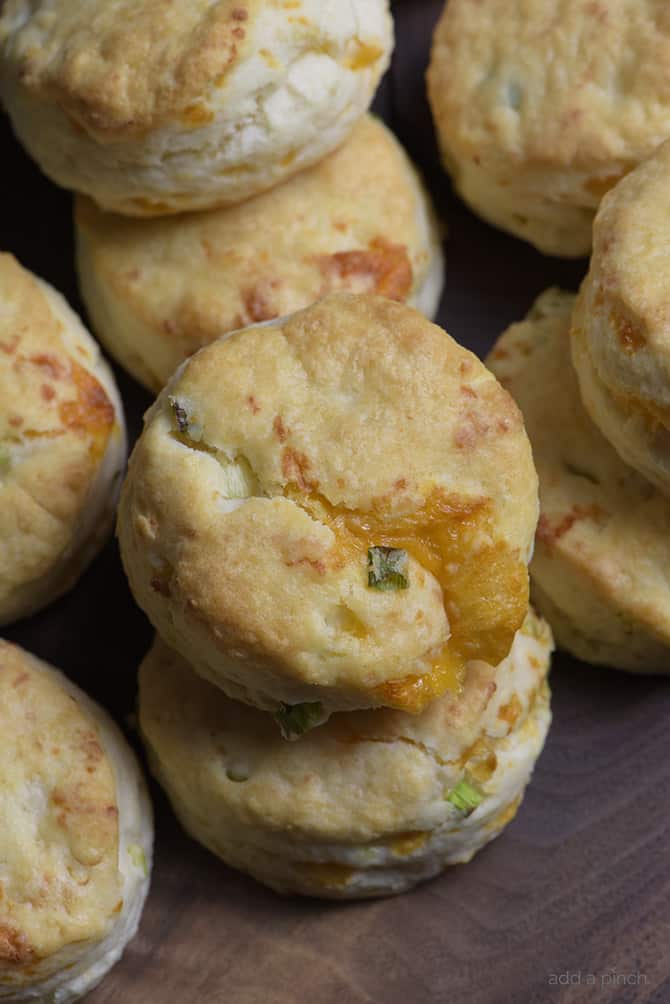 Cheddar Scallion Biscuits Recipe - Tender and delicious, these fluffy, cheesy cheddar scallion biscuits make the perfect addition to any meal and couldn't be easier! // addapinch.com