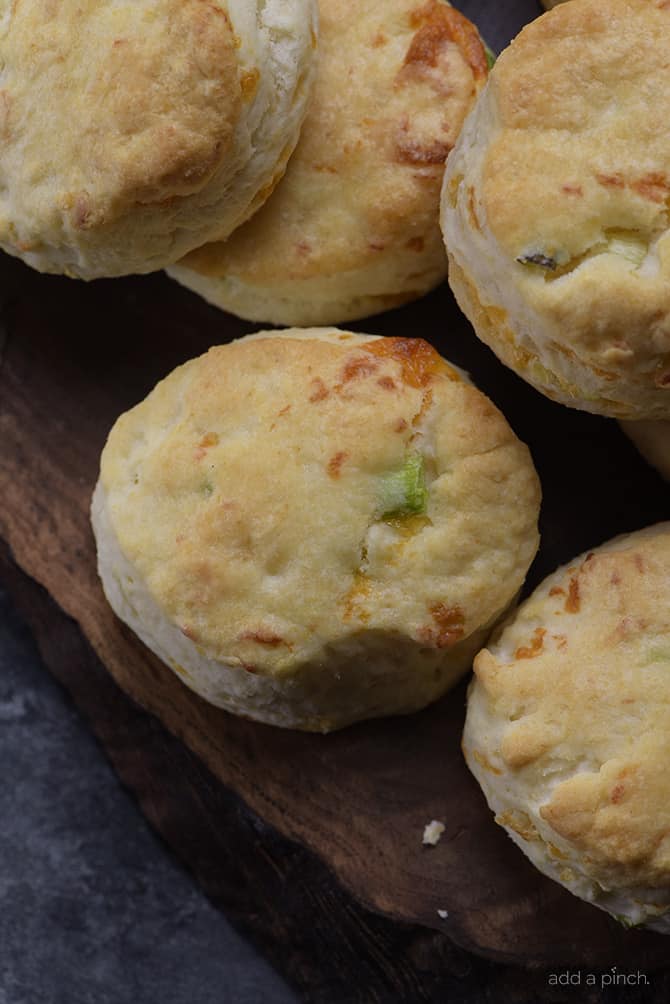 Cheddar Scallion Biscuits Recipe - Tender and delicious, these fluffy, cheesy cheddar scallion biscuits make the perfect addition to any meal and couldn't be easier! // addapinch.com