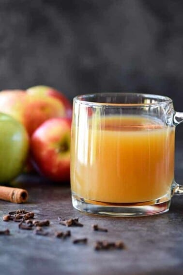 Homemade Apple Cider Recipe - Easy and delicious homemade apple cider recipe made with apples, oranges, cinnamon, and cloves. Stovetop and slow cooker instructions included! // addapinch.com