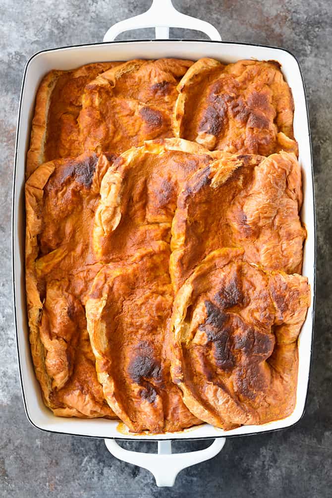 Browned bread pudding with pumpkin in white casserole dish // addapinch.com