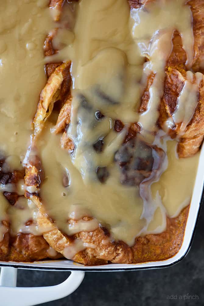 Closeup of maple cream sauce atop bread pudding.