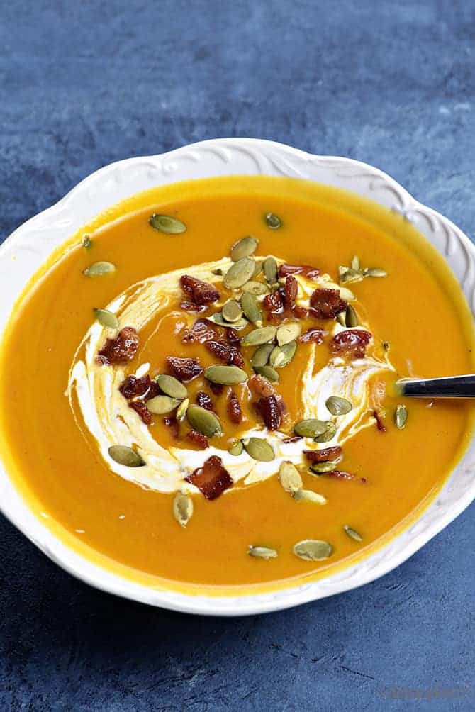 Creamy Pumpkin Soup Recipe - This classic pumpkin soup recipe is creamy, dreamy and made without cream! Quick and easy, this pumpkin soup comes together in a snap for simple weeknight or when entertaining through the holidays! // addapinch.com