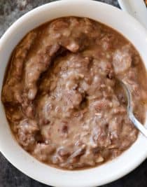 Refried Beans Recipe - This quick and easy refried beans recipe made with pinto beans, onion, and spices makes a delicious side dish for so many meals! // addapinch.com