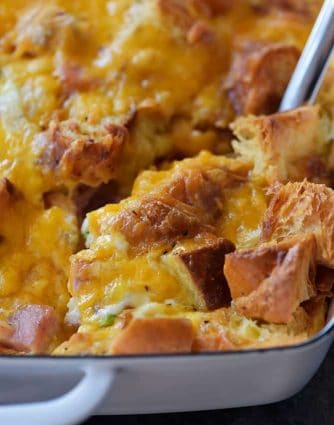 Ham and Cheese Croissant Casserole Recipe - An easy and delicious breakfast casserole that everyone loves! Made of ham, two cheeses, and buttery croissants and baked to perfection! // addapinch.com