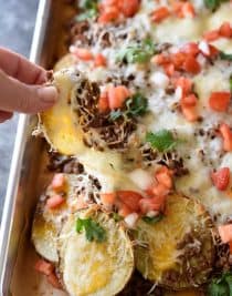 Loaded Potato Skin Nachos Recipe - These nachos will quickly become a favorite with the blend of loaded potato skins and spicy nachos all in one! // addapinch.com