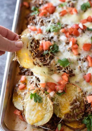 Loaded Potato Skin Nachos Recipe - These nachos will quickly become a favorite with the blend of loaded potato skins and spicy nachos all in one! // addapinch.com