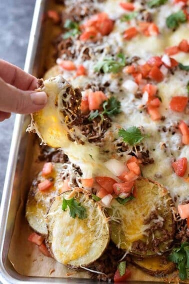 Loaded Potato Skin Nachos Recipe - These nachos will quickly become a favorite with the blend of loaded potato skins and spicy nachos all in one! // addapinch.com