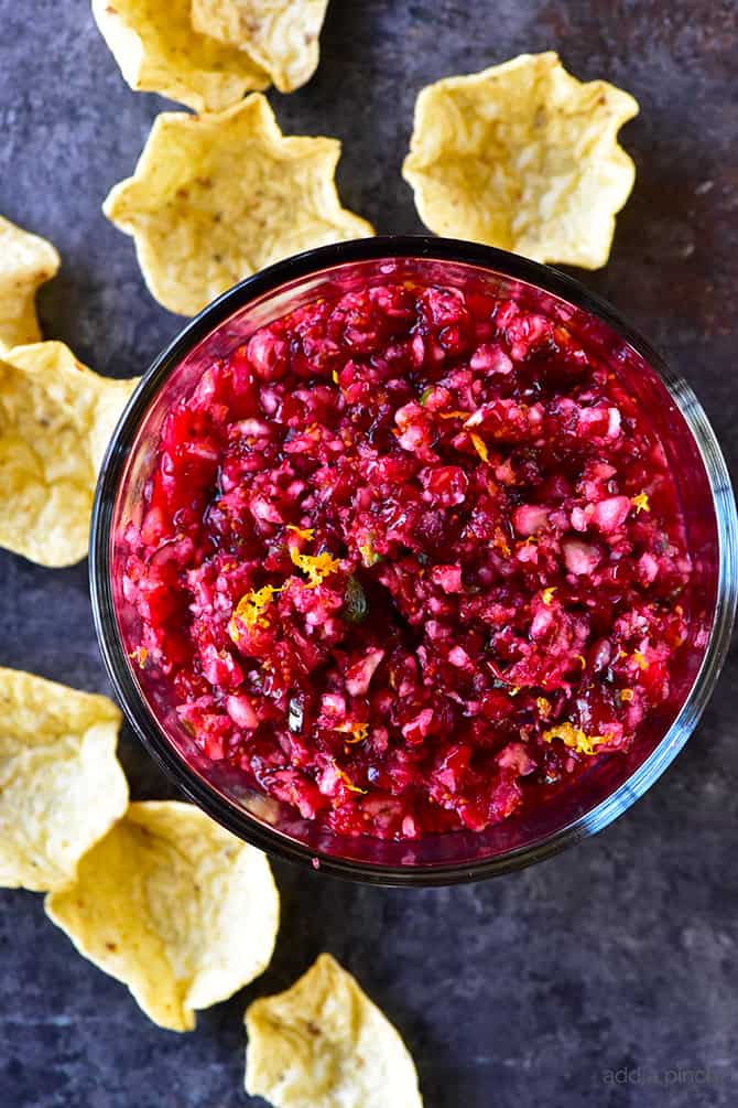 Orange Cranberry Salsa Recipe - Fresh cranberry salsa is a sweet fruit salsa recipe that adds color, flavor and wow to any dish! Perfect throughout the holidays! // addapinch.com