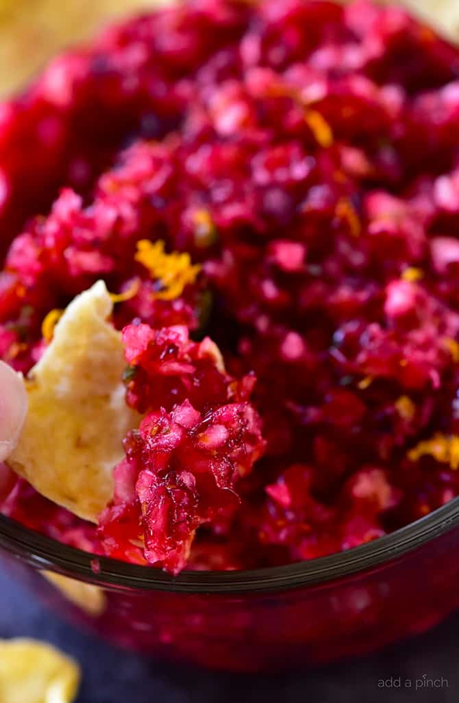 Orange Cranberry Salsa Recipe - Fresh cranberry salsa is a sweet fruit salsa recipe that adds color, flavor and wow to any dish! Perfect throughout the holidays! // addapinch.com