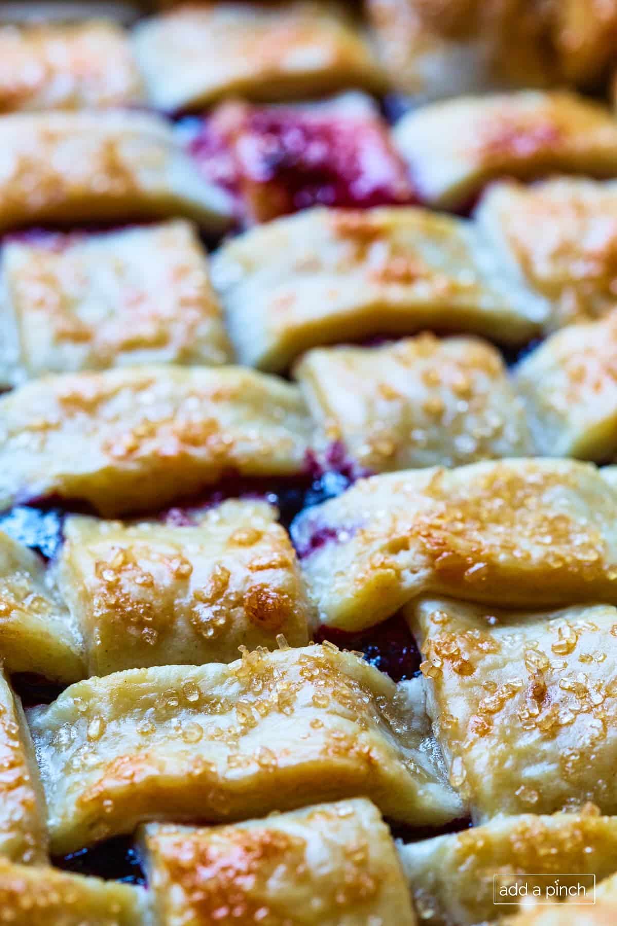 Lattice pie crust on a golden baked cherry pie. 