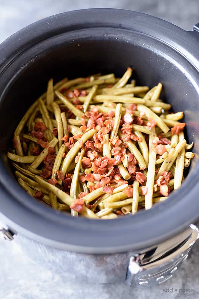 Slow Cooker Green Beans Recipe - These are the best slow cooker green beans and have everyone coming back for more! // addapinch.com