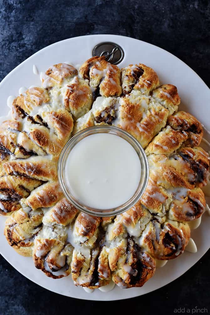 Cinnamon Roll Biscuit Wreath with icing cup in the middle.