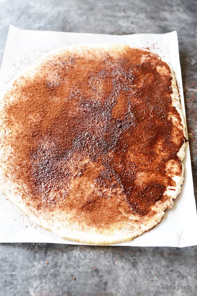 Dough with cinnamon mixture spread on it // addapinch.com