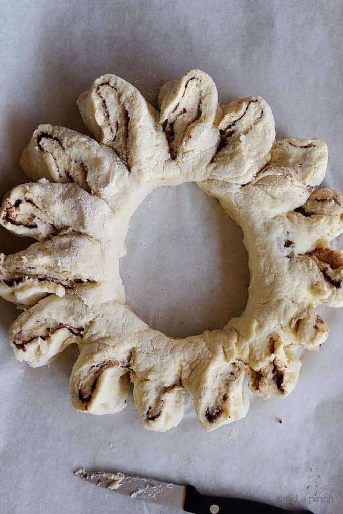 Shaping Cinnamon Roll Biscuit dough into shape of wreath. 