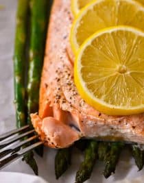 Lemon Garlic Salmon and Asparagus Parchment Packet Recipe - This quick and easy recipe comes together in a snap and is ready and on the table in 15 minutes! // addapinch.com