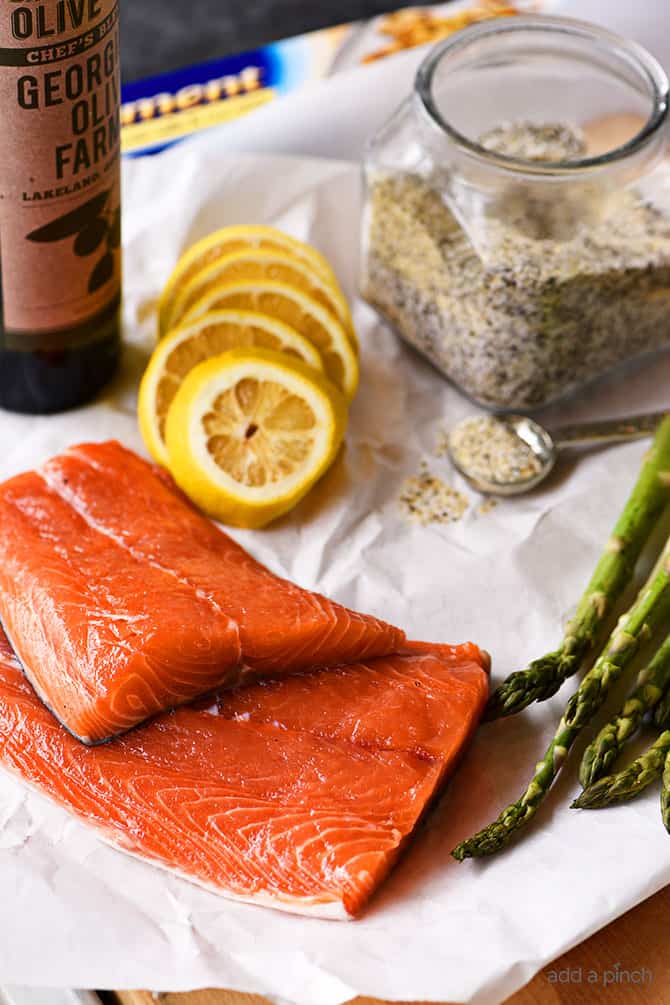 Lemon Garlic Salmon and Asparagus Parchment Packet Recipe - This quick and easy recipe comes together in a snap and is ready and on the table in 15 minutes! // addapinch.com