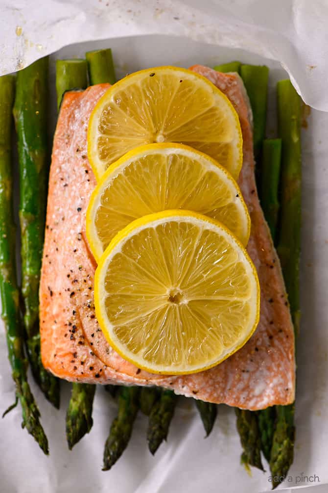 Lemon Garlic Salmon and Asparagus Parchment Packet Recipe - This quick and easy recipe comes together in a snap and is ready and on the table in 15 minutes! // addapinch.com