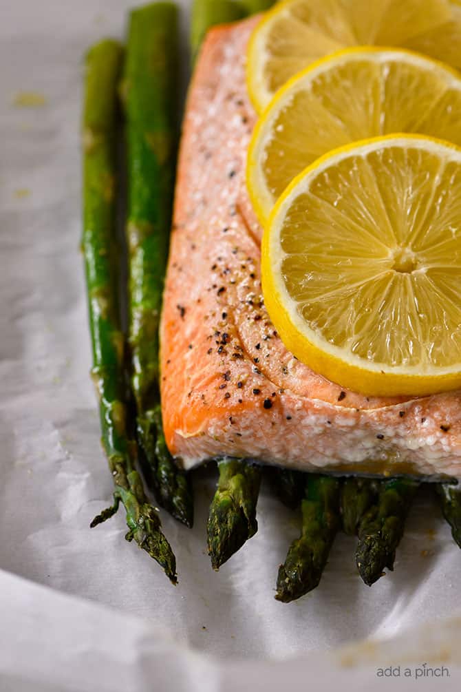 Lemon Garlic Salmon and Asparagus Parchment Packet Recipe - This quick and easy recipe comes together in a snap and is ready and on the table in 15 minutes! // addapinch.com