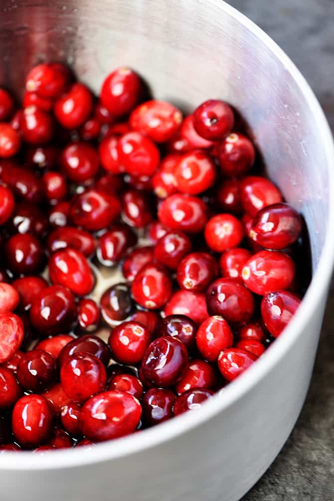 Bowl of cranberries in simple syrup // addapinch.com