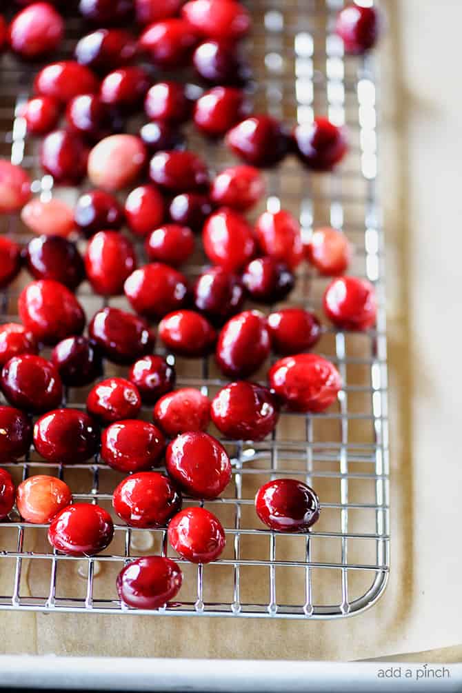 Cranberries on a wired cooling sheet.  // addapinch.com