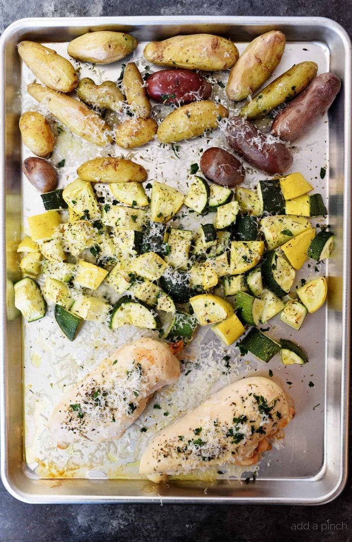 Sheet Pan Parmesan Chicken and Vegetables Recipe - This super easy, 30 minute meal makes a simple, yet scrumptious supper of juicy chicken and vegetables topped with Parmesan! // addapinch.com