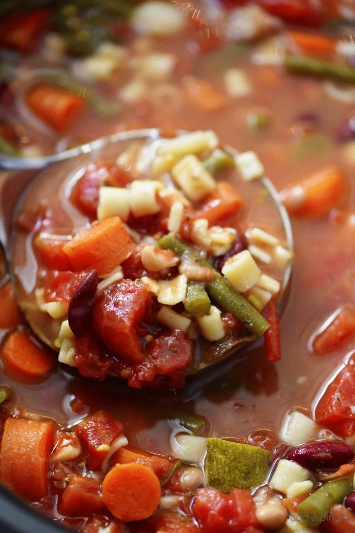 This savory Slow Cooker Minestrone Soup Recipe is full of seasonal vegetables and made even easier in this slow cooker recipe! A delicious family favorite! // addapinch.com