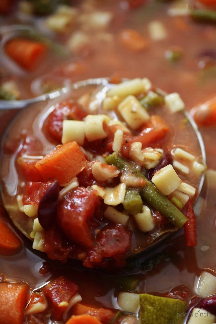 This savory Slow Cooker Minestrone Soup Recipe is full of seasonal vegetables and made even easier in this slow cooker recipe! A delicious family favorite! // addapinch.com