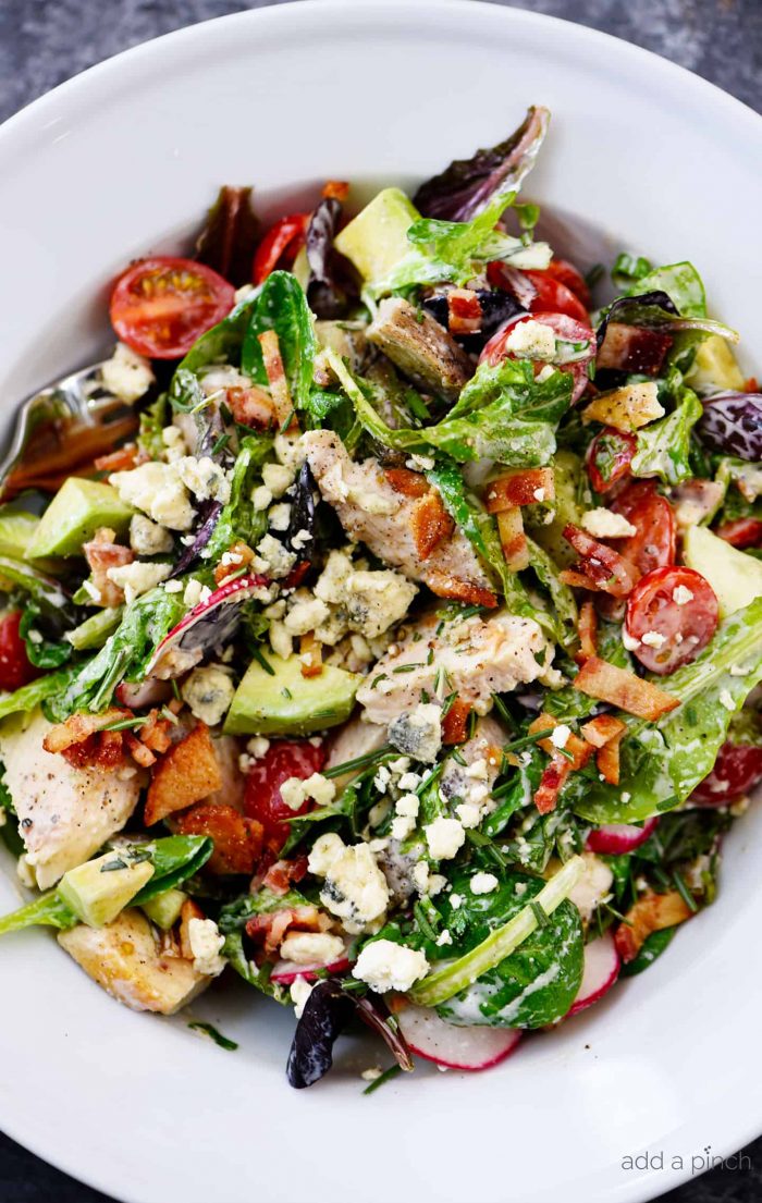 Rosemary Chicken Salad Recipe with Rosemary Ranch Dressing - Tender baked rosemary chicken is the star in this loaded salad recipe topped with a flavorful rosemary ranch dressing. The perfect combination of crunch, creamy, salty and so, so good! // addapinch.com