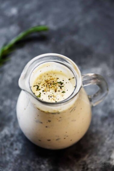 Rosemary Ranch Dressing Recipe - This simple ranch dressing is an update to the classic ranch dressing with fresh rosemary and spices and adds so much flavor to salads, chicken, and so many dishes! // addapinch.com