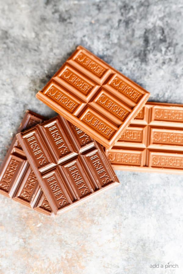 Photograph of milk and dark Hershey's Chocolate Bars on a gray background // addapinch.com