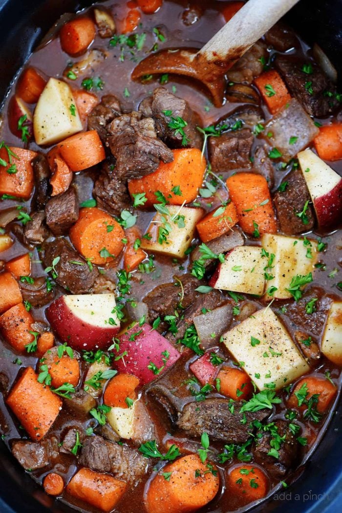 Beef, red potatoes, sliced carrots, onions, fresh thyme in a rich sauce in slow cooker.