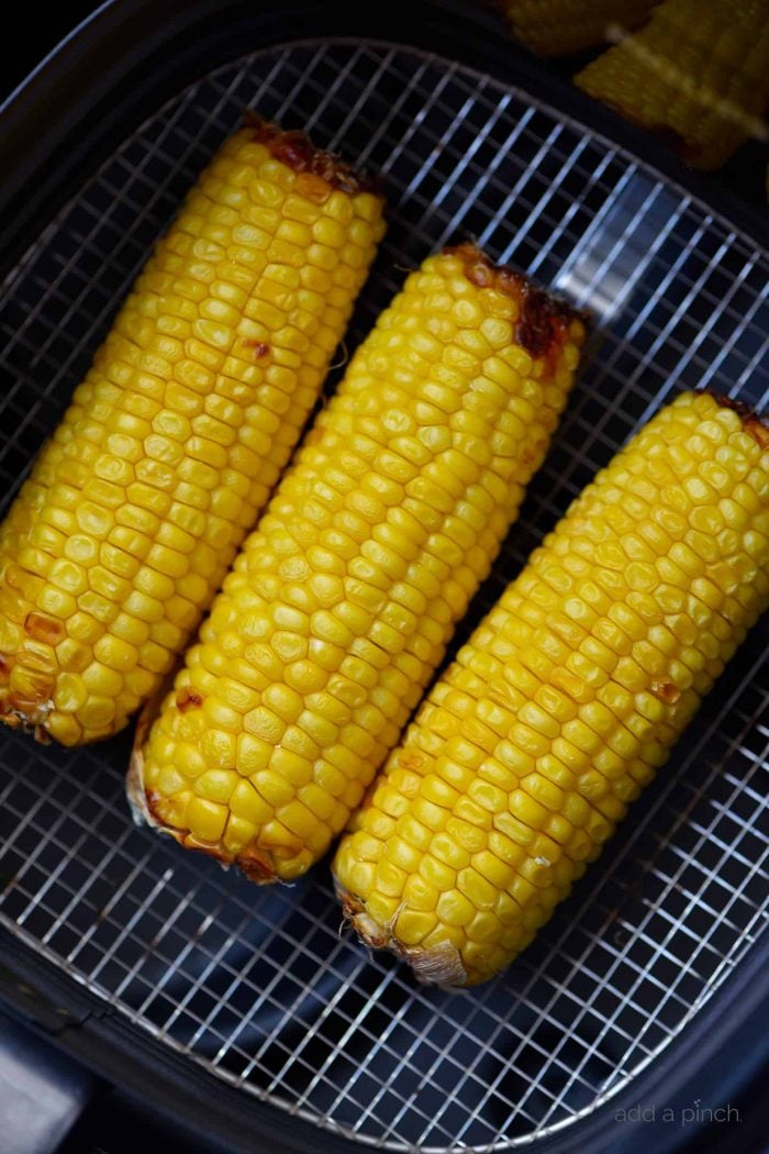 Air Fryer Mexican Street Corn Recipe - This flavorful, super easy Mexican Street Corn recipe is ready in 15 minutes in the air fryer and always a favorite! // addapinch.com