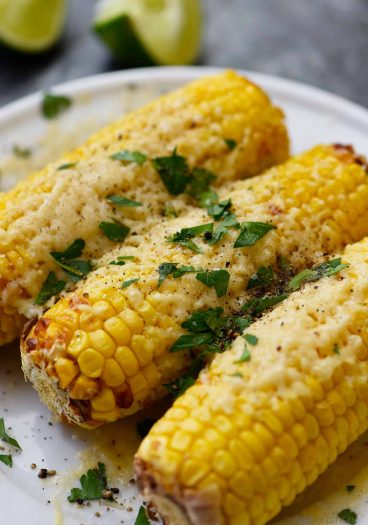 Air Fryer Mexican Street Corn Recipe - This flavorful, super easy Mexican Street Corn recipe is ready in 15 minutes in the air fryer and always a favorite! // addapinch.com