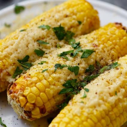 Air Fryer Mexican Street Corn Recipe - This flavorful, super easy Mexican Street Corn recipe is ready in 15 minutes in the air fryer and always a favorite! // addapinch.com