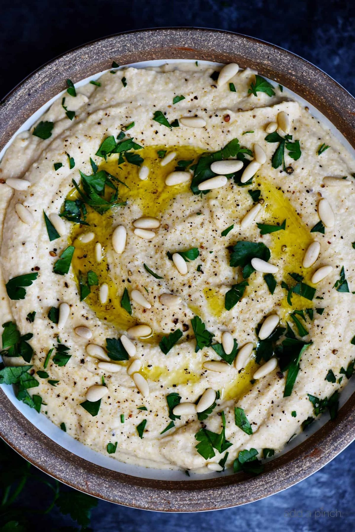 Classic Hummus Recipe - A traditional hummus recipe ready in minute! Perfect to serve as a snack, appetizer, or spread for sandwiches and wraps! // addapinch.com