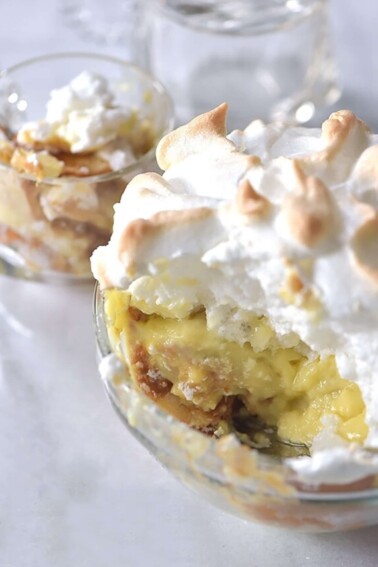 Photo of banana pudding with meringue topping on a white background.