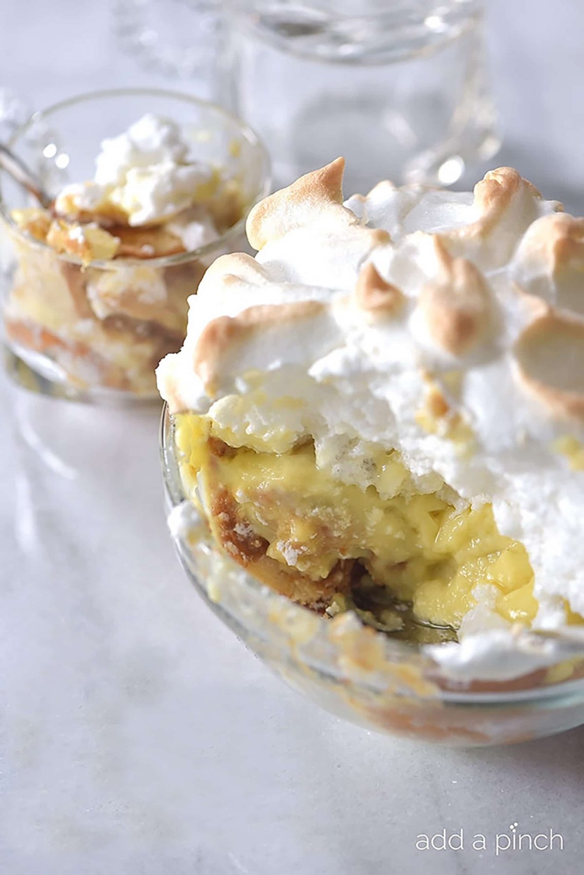 Southern Banana Pudding Recipe - An heirloom family recipe for banana pudding that is a classic, Southern dessert. Creamy, traditional banana pudding topped with airy meringue. // addapinch.com